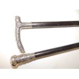 A Chinese white metal mounted swagger stick, 26" and another, 20.5" - possibly cut down. (2)