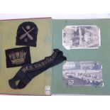 An album containing WWII postcards showing service on HMS Vanguard, including cap tally and two