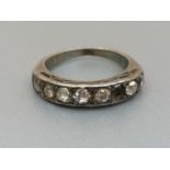 An old cut diamond half eternity ring set in white metal. Finger size J - one stone missing.