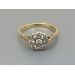 A small diamond cluster ring on 18ct gold shank, London marks. Finger size N/O.