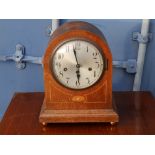 An inlaid oak chiming mantel clock with German movement.