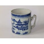 An antique Chinese blue & white porcelain cylindrical tankard, decorated with pagodas by water