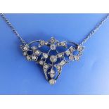 A late Victorian paste set silver pendant necklace, the openwork pendant 1.75" across.