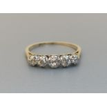 A small graduated five stone diamond ring in 18ct & Plat. Finger size N.