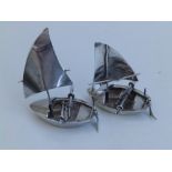 A pair of silver rowing boats with sails, 2.8" across. (2)