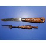 An early 19thC knife & fork, having carved wooden pelican handles dated 1827, the knife blade marked