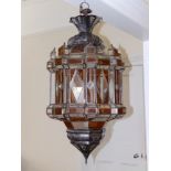 A large North African metal frame hanging lantern fitted with amber & colourless glass panels, 34"