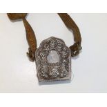 A Tibetan copper prayer Gau with silver front, three pieces of silk to interior printed with
