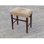 A George V Coronation stool with upholstered top on square tapering legs.