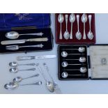 Two cased sets of silver teaspoons, a three piece christening set and seven other pieces of cutlery.