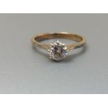 A diamond solitaire ring, the claw set brilliant weighing approximately 0.50 carat on yellow metal