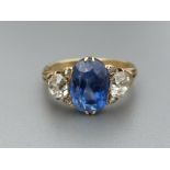 An Edwardian certified natural Sri-Lankan sapphire & diamond three stone ring, the oval cut sapphire