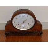 A 1920's presentation chiming mantel clock with oval dial and German movement, with detached