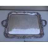 A large EP two-handled tea tray with leaf cast rim, stamped 'Courage' in small lettering to