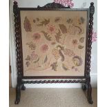 A Victorian spiral twist oak firescreen with floral embroidered panel, 33.5" high.