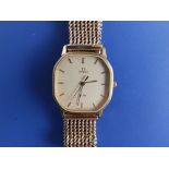 A gent's gold plated Omega De Ville quartz wrist watch on 9ct gold strapwith patent expanding clasp,