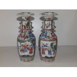 A pair of 19thC Cantonese porcelain shouldered vases, having small Buddhistic lion moulded handles