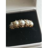 A 9ct ring set with five graduated pearls. Finger size L.