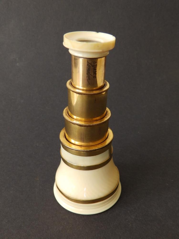 A 19thC three-drawer gilt brass & ivory monocular with gold banding by Adams, London, 4" extended,
