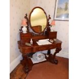 A Victorian mahogany duchesse dressing table having fretwork gallery & scrolling front legs,