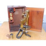 A brass microscope by Mason in 12" high mahogany case.