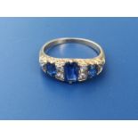 A sapphire & diamond set ring, having three sapphires and six rose cut diamonds - tests as 18ct