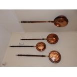 Four antique copper warming pans. Separate viewing arrangements by appointment. Hall.
