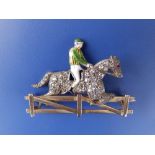 A Victorian diamond set & enamelled gold jockey brooch, the horses body pave set with numerous small