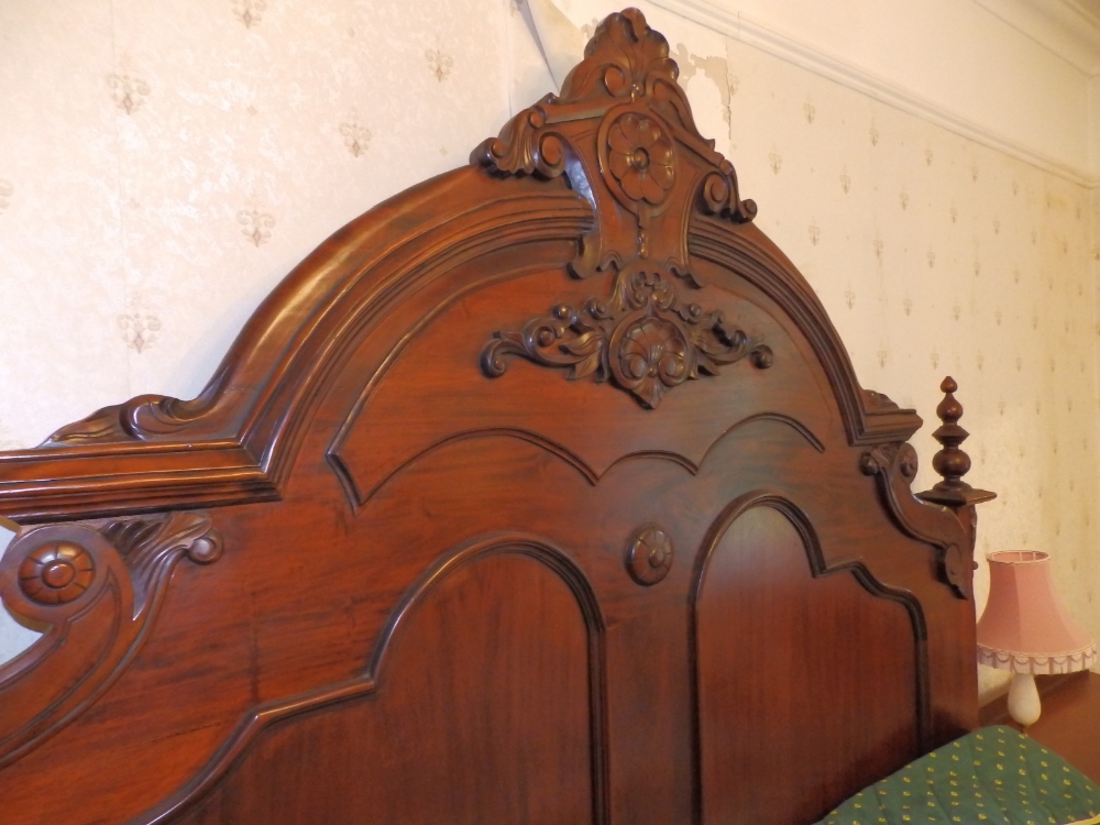 A Victorian style mahogany king size double bed, the high arched headboard with carved panelled - Image 2 of 4