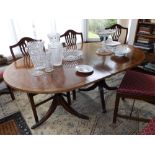 A 20thC reproduction mahogany twin pillar dining table. Separate viewing arrangements by