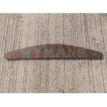 A rosewood grained lintel sign for 'Wyman', in green painted lettering, double-sided, 51" across.