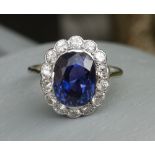 A certified natural 5.19 carat colour change sapphire & diamond oval cluster ring in white metal,