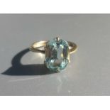 A small aquamarine solitaire ring - tests as 18ct. Finger size C/D.