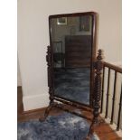 A Victorian mahogany cheval mirror, the spiral turned uprights on lion paw feet, Height 60", Width