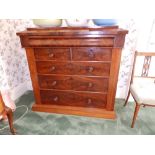 A Victorian mahogany chest of drawers with concealed drawer in the projecting cornice over two short