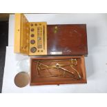 A 19thC mahogany cased set of travelling scales and some weights.