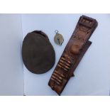 A brass 'capper' a WWII artillery officer's cap and a cartridge belt. (3)