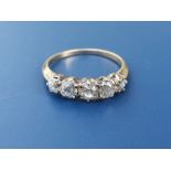 An early 20thC five stone old cut graduated diamond ring, the central claw set stone weighing