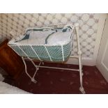A painted iron rocking crib on casters and other nursery items. Separate viewing arrangements by