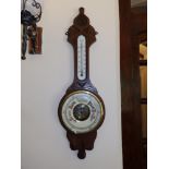 A Victorian oak banjo barometer with enamelled dial having red lettering, 32". Separate viewing