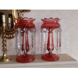 A pair of Victorian cranberry glass lustres, 13" high. Separate viewing arrangements by
