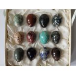 A set of 12 coloured mineral specimen 'eggs', each bearing a paper inventory number, 1.6".