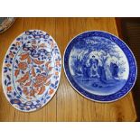 An Oriental blue & white porcelain charger decorated with two sages in a garden, 14.5" diameter