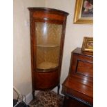 A marble top corner vitrine with ormolu mounts, single bowed glazed door. Height 63", Width 24".