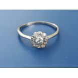 A diamond cluster ring on 18ct white shank. Finger size U.