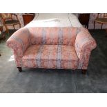 A small drop-end Chesterfield sofa on turned front legs, Width 57" - upholstery a/f. Separate