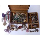 A small leather covered jewellery box containing Military Police medals, brooches and other