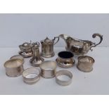 A Birmingham silver sauceboat, four silver condiment pieces and six napkin rings. (11)