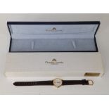 A boxed lady's gold plated Marice Lacroix quartz wrist watch with date indicator, on replacement
