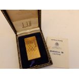 A cased Dunhill 70 gold plated lighter with instruction booklet.